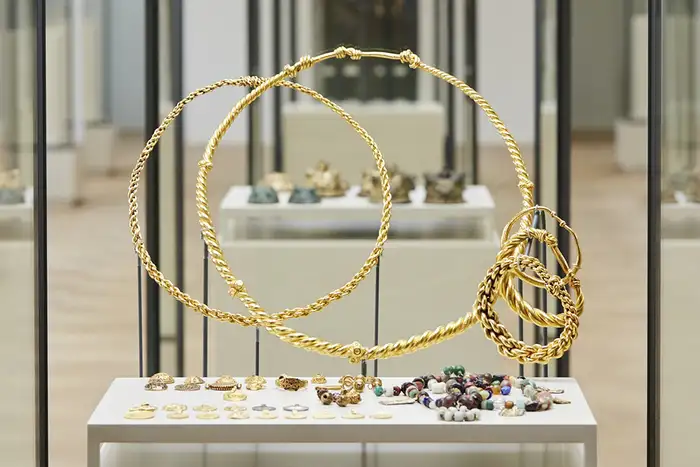 A Viking Age treasure on display in a museum glass case.
