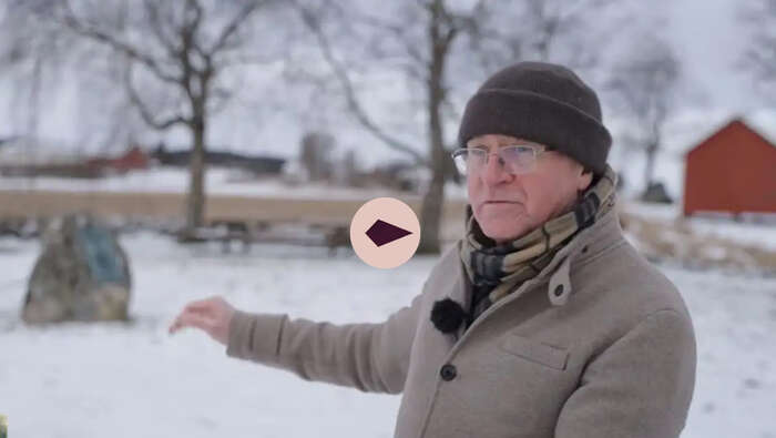 Man looking towards the camera, winter lanscape in the background